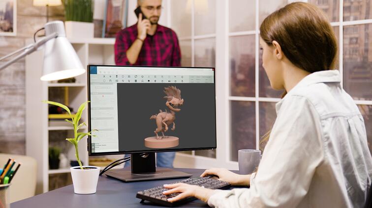 Man en vrouw werken op kantoor aan een computermodel.